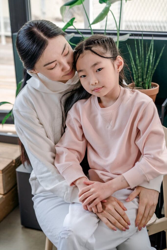 pexels-photo-9508856 A tender moment between mother and daughter sitting together indoors.